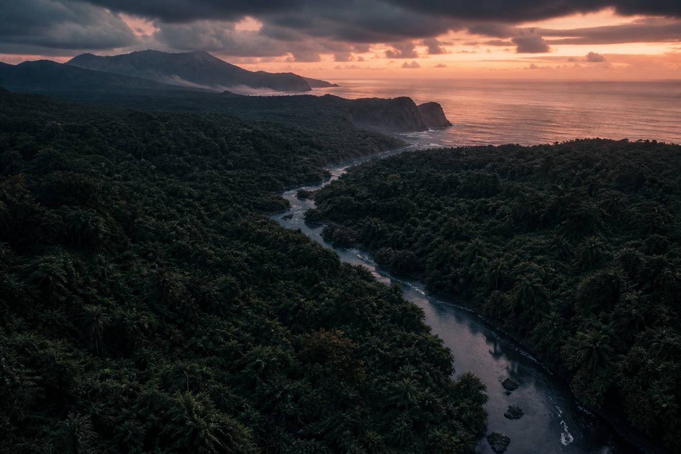 River cutting through jungle toward coastal cliffs on the island